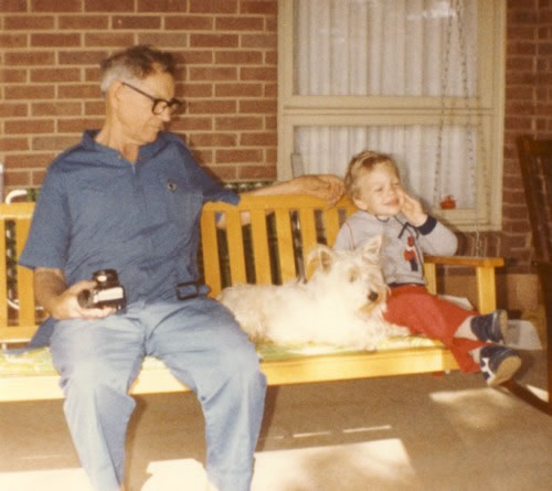 Granddaddy with camera on the porch swing